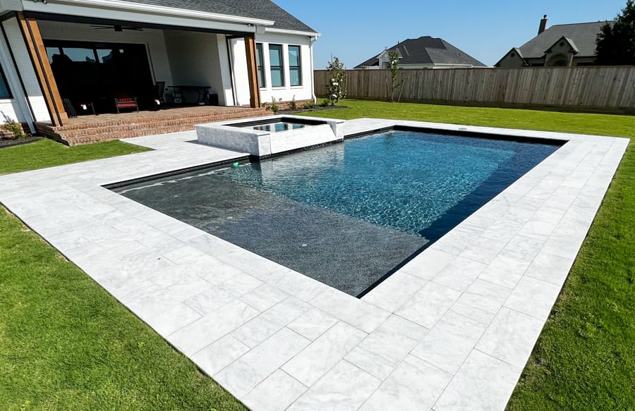 Rectangle gunite pool with raised spa in College Station.