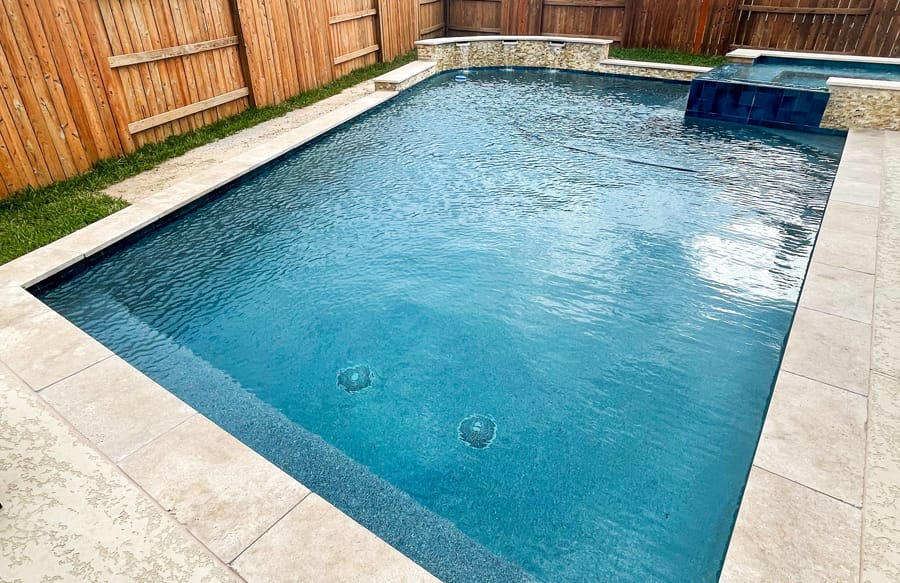 Modified rectangle gunite pool in College Station backyard.