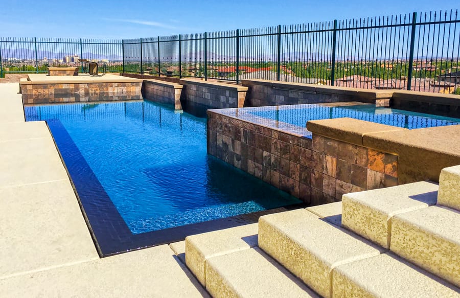 Full-perimeter overflow custom pool built in Tucson.