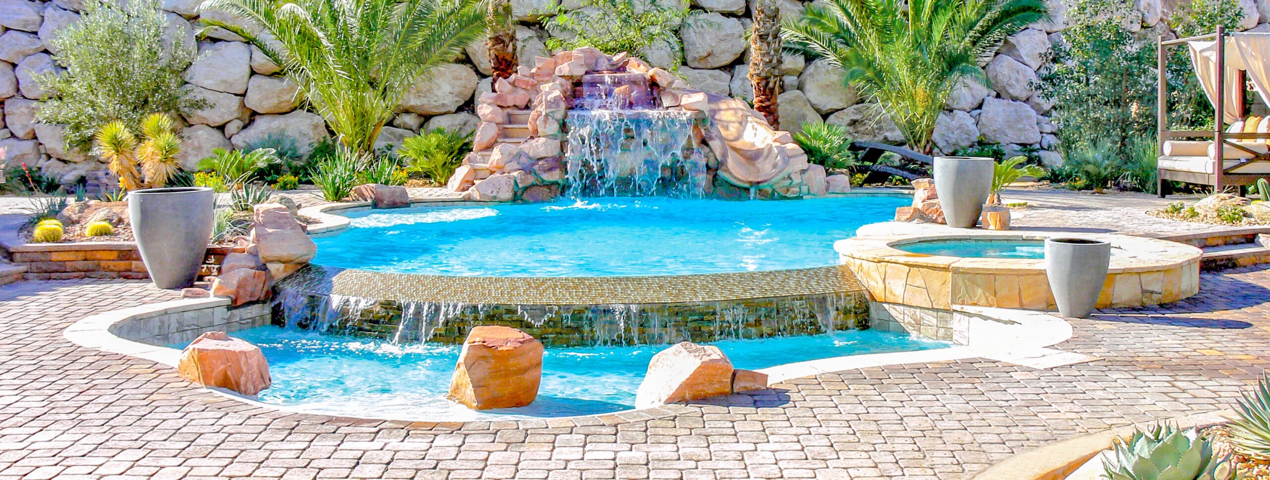 Lagoon-style gunite pool with rock waterfall in Southern Arizona.